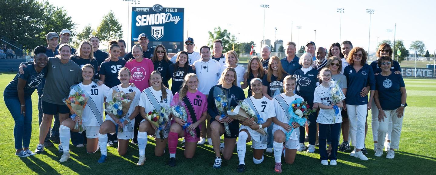 Senior Day at Jeffrey Field — honoured players kneel with bouquets while families and staff stand behind them