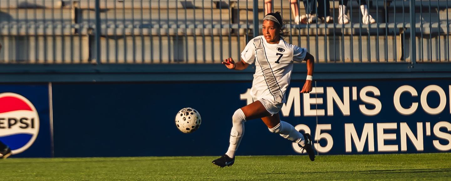 A Penn State player follows through on a strike with the ball in flight